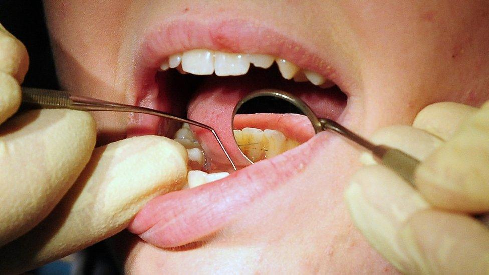 Dentist checking a patient's teeth