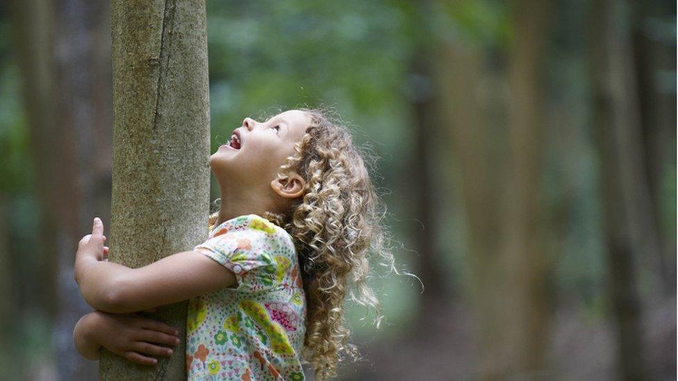 girl hugging tree