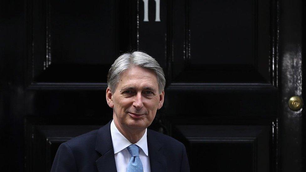 Chancellor of the Exchequer Philip Hammond poses outside 11 Downing Street during his first day in the role on July 14, 2016