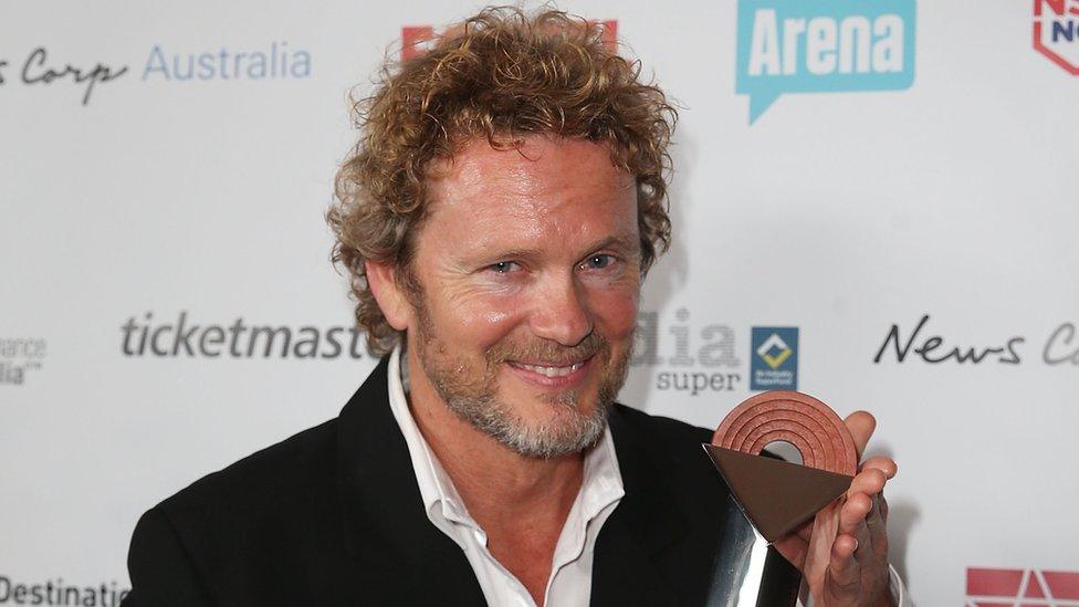 Craig McLachlan with an award in 2014