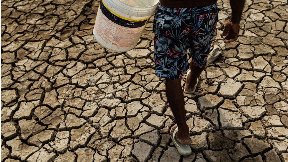 Fisherman and trader Raimundo Silva do Carmo, 67, fetches water from a well, Lago do Puraquequara lake, Manaus, Brazil