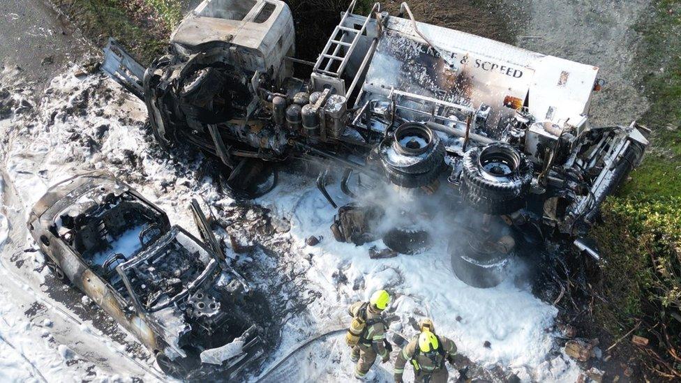 Overturned cement mixer and car