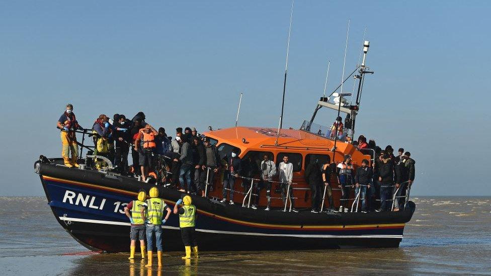 A group of migrants picked up by an RNLI boat and taken to shore at Dungeness