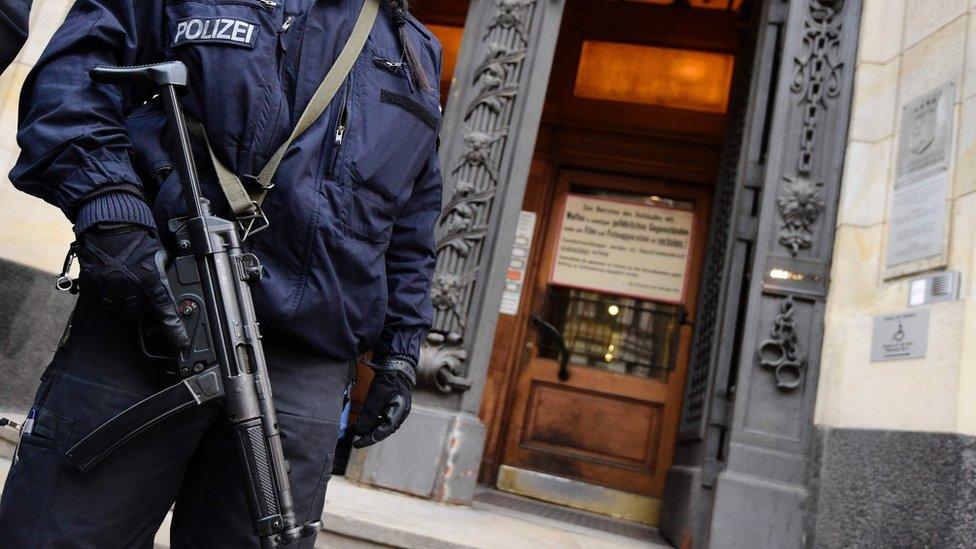 Armed police are stationed outside the Berlin court where alleged Islamic State jihadist Shaas al-M went on trial on Wednesday