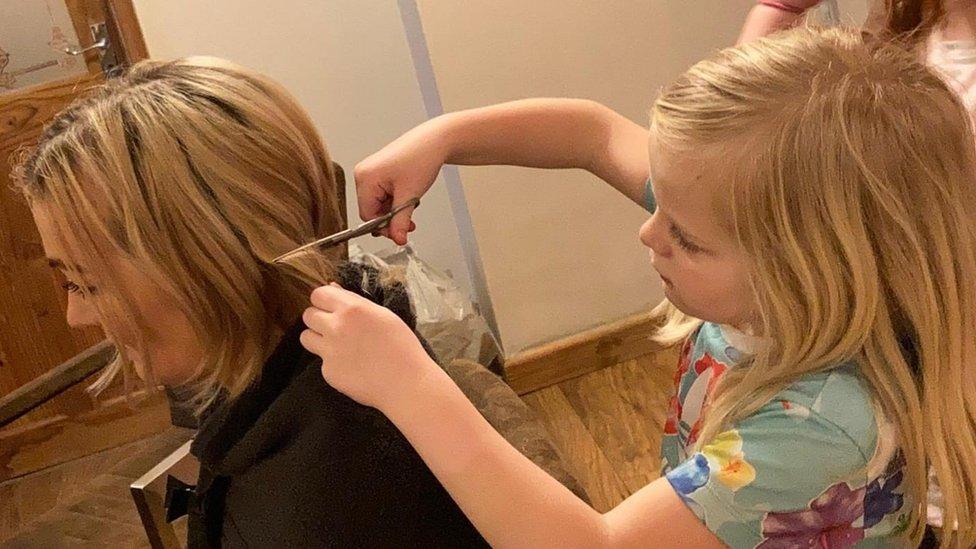 Justine Jianikos having her hair cut