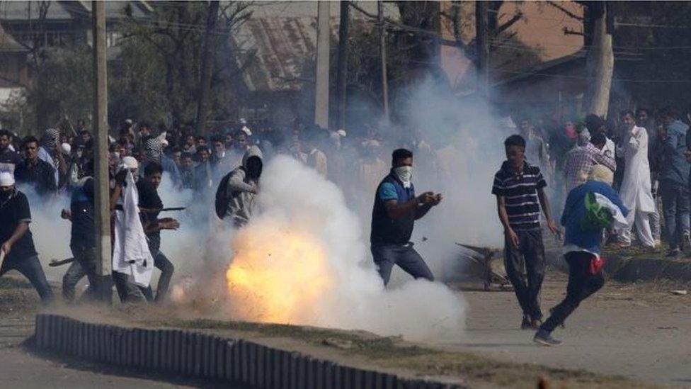 A teargas shell explodes in front of Kashmiris protesting outside Eidgah, a prayer ground, in Srinagar, Indian controlled Kashmir,