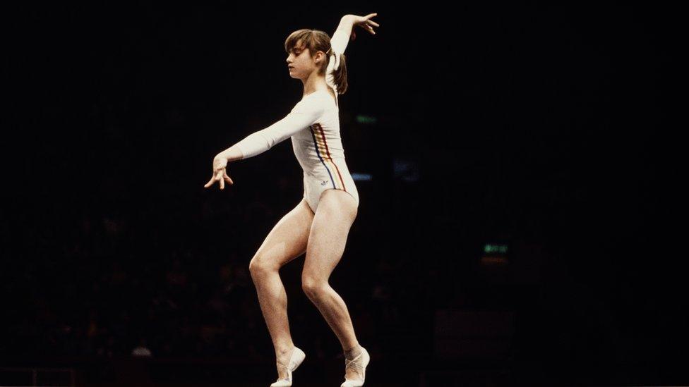 Nadia Comaneci of Romania performs her routine on the Balance Beam during the Women's Artistic Team all-around event on 19 July 1976 during the XXI Olympic Summer Games at the Montreal Forum, Montreal, Canada