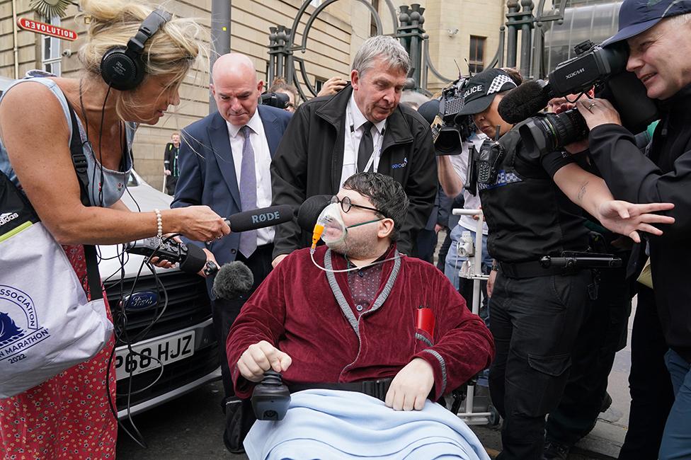 Nicholas Rossi outside court surrounded by reporters