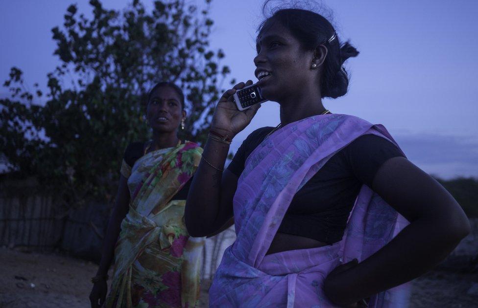 Amudha speaking on a mobile phone.