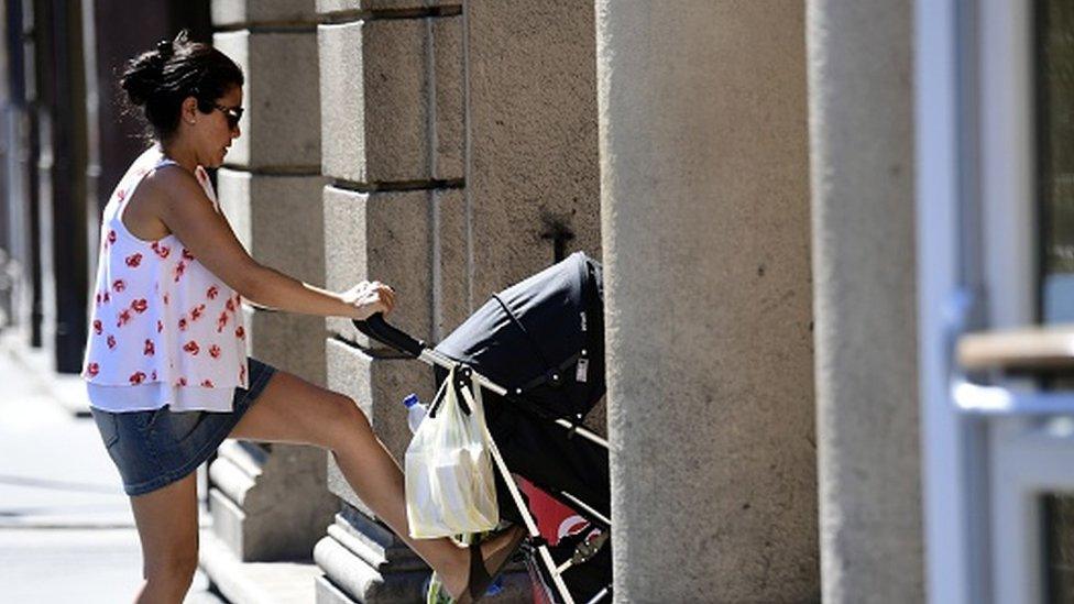 A mother pushes a pram in Budapest (11 July 2016)