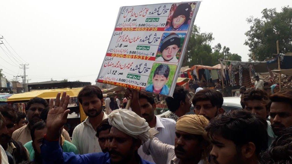 Protesters of Kasur with posters showing the missing boys