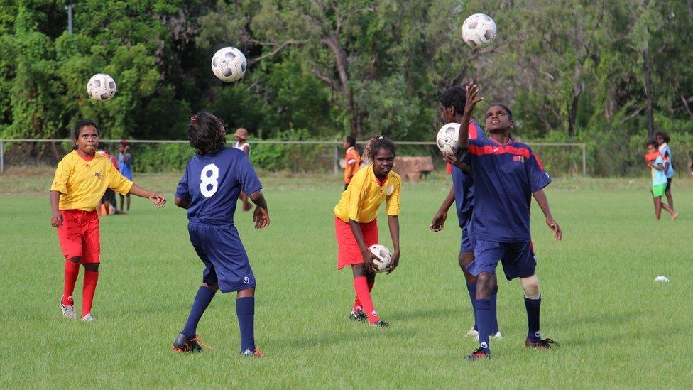 Children play football at Borroloola, in Australia's Northern Territory