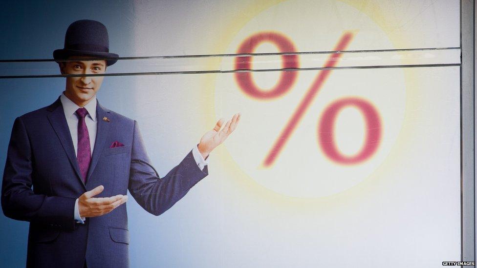 Man posing in front of percentage sign