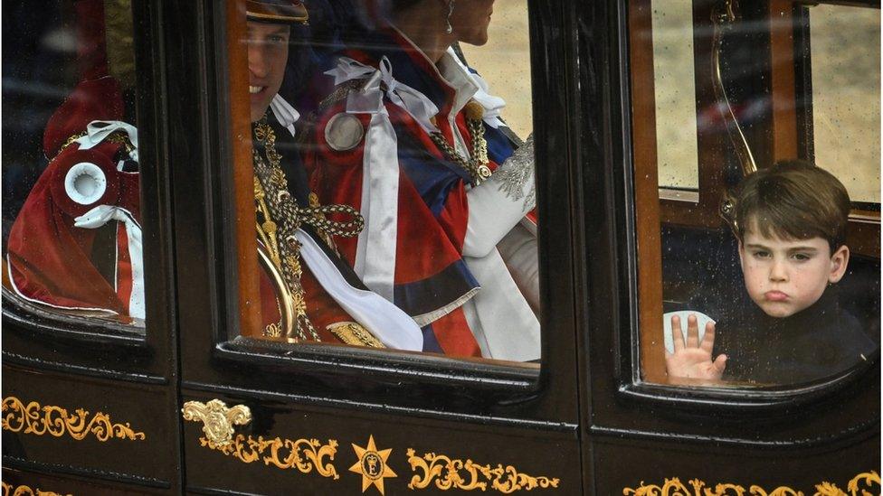 Prince William, Prince of Wales, Britain's Catherine, Princess of Wales and Prince Louis of Wales travel back to Buckingham Palace from Westminster Abbey in central London