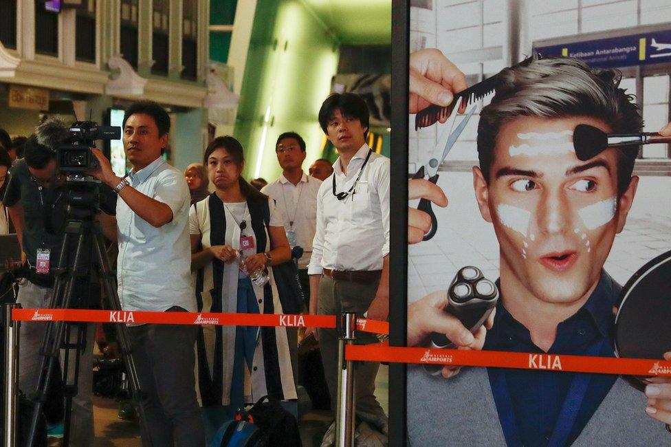 Media members react during a revisit to the scene of the assassination of Kim Jong-nam, the estranged half-brother of North Korea"s leader Kim Jong-un, by the suspects Siti Aisyah of Indonesia and Doan Thi Huong of Vietnam, at the Kuala Lumpur International Airport 2 in Sepang, Malaysia, 24 October 2017.