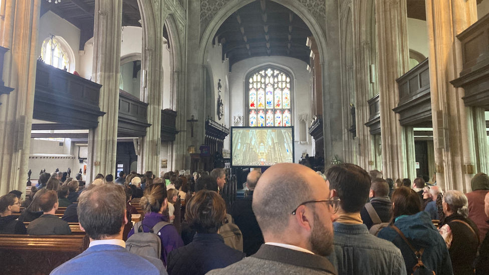 Mourners gathering for the Queen's funeral at Great St Mary's Church in Cambridge