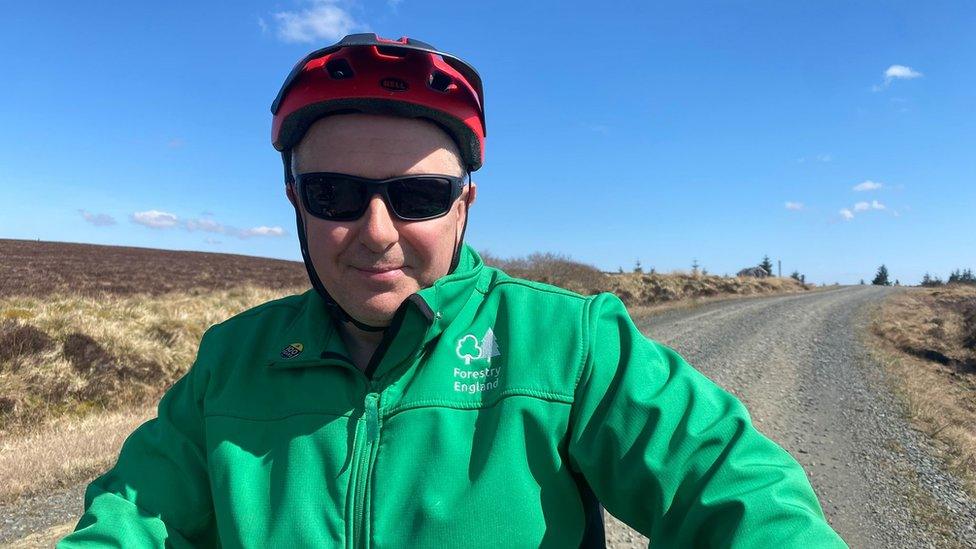 Alex MacLennan on a bike on a gravel path