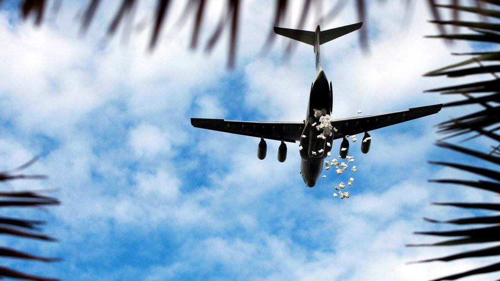 A World Food Programme plane releases sacks of food during an airdrop near the town of Nyal, in South Sudan, 20 August 2018