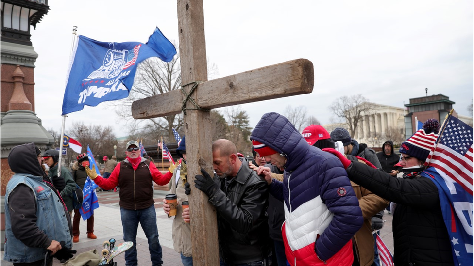 Supporters of President Donald Trump pray outside the US Capitol on 6 January