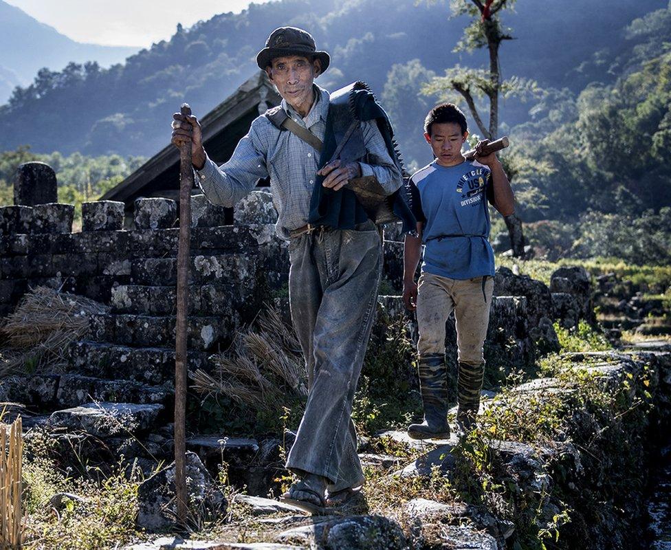 Men from the Khonoma tribe are seen walking in the village.