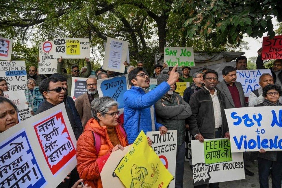 Teachers of Jawaharlal Nehru University (JNU) hold placards as they shout slogans during a protest against an attack on the university students and teachers at the JNU campus in New Delhi on January 6, 2020.