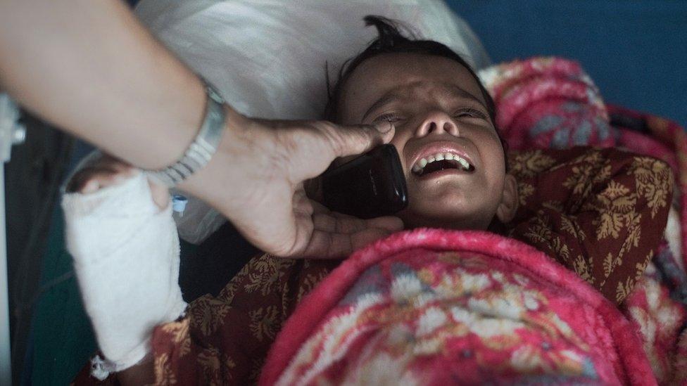 A young injured girl speaks to her mother via mobile after April's devastating earthquake in Nepal