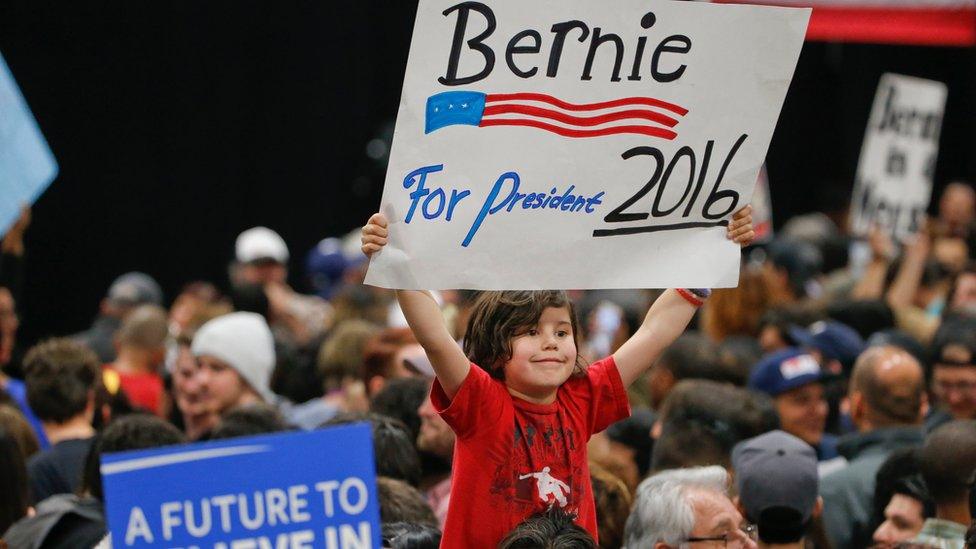 A child holds a sign supporting Democratic presidential candidate Sen. Bernie Sanders, I-Vt., while awaiting his arrival at the San Diego Convention Center