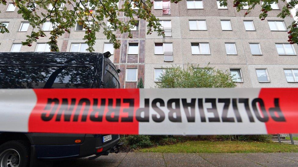 A vehicle of the German Criminal Police is seen behind a police tape cordoning off the area as officers investigate an apartment in the Paunsdorf district of Leipzig, Saxony, Germany, 10 October 2016.