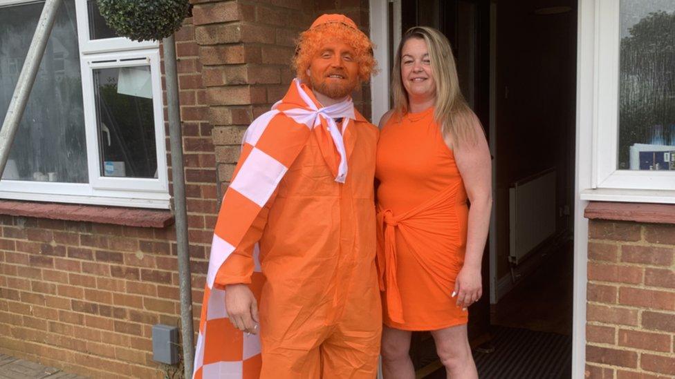 Micky Hyde dressed in Luton orange with his fiancee