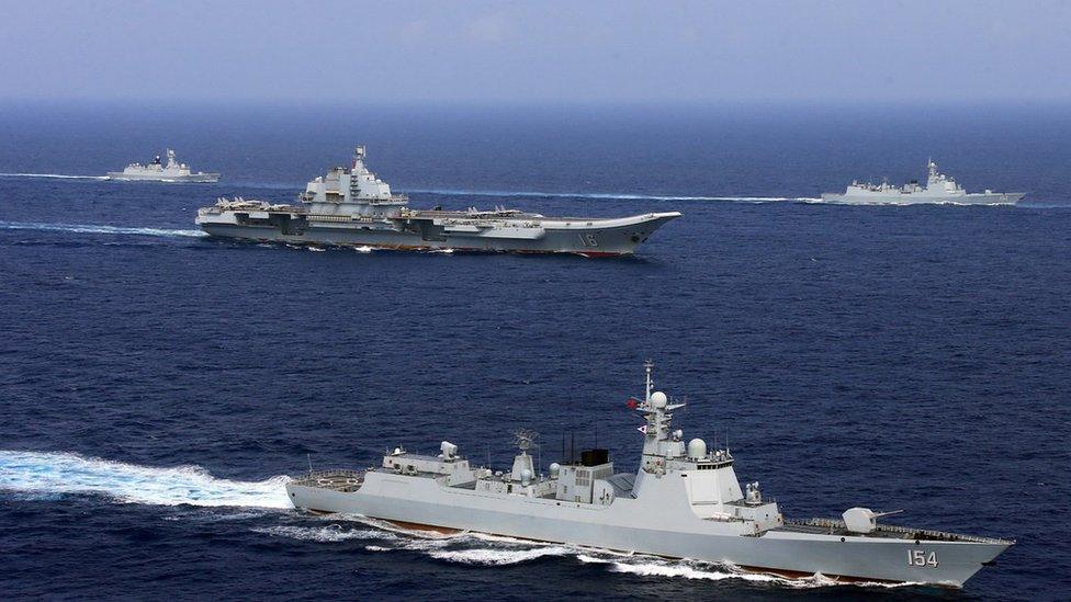 China's aircraft carrier Liaoning (c) takes part in a military drill of Chinese People's Liberation Army Navy in the western Pacific Ocean, April 2018