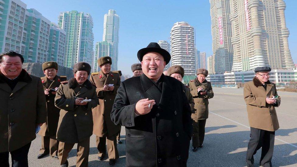 Kim Jong-un smoking as he walks on a visit