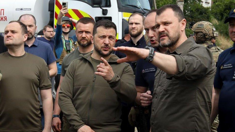 Ukrainian President Volodymyr Zelensky (C) speaks to Ihor Klymenko (R), head of the National Police of Ukraine, during a visit to Kherson, Ukraine, 08 June 202