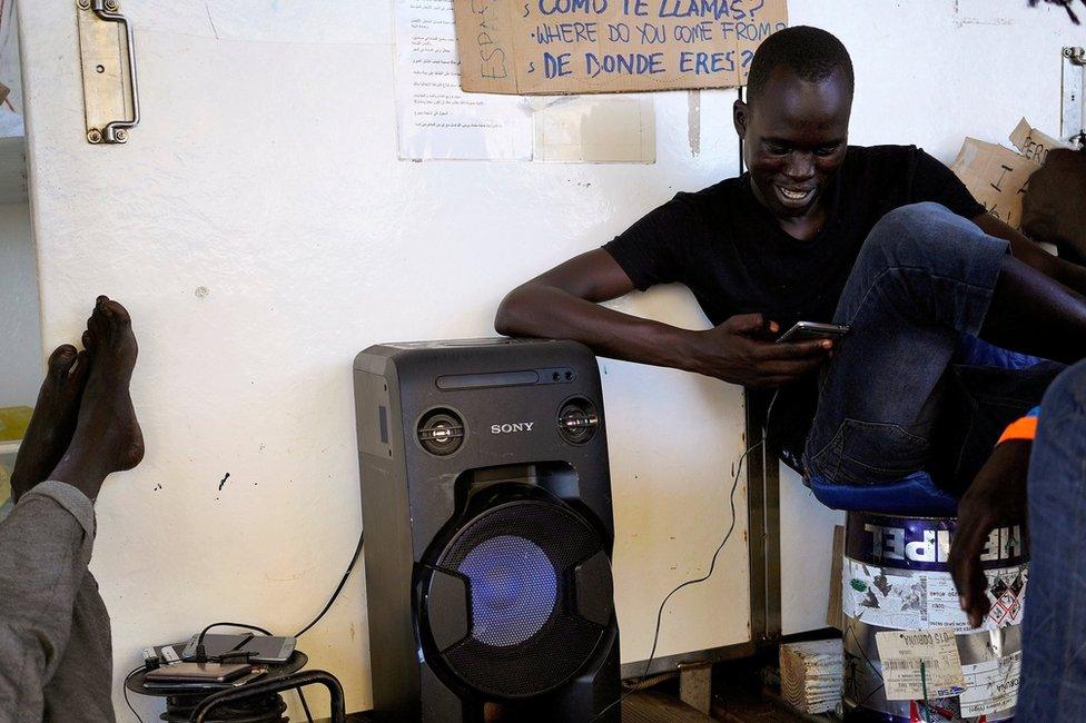 Chuol, 17, from Sudan, listens to the music on board NGO Proactiva Open Arms rescue boat in central Mediterranean Sea