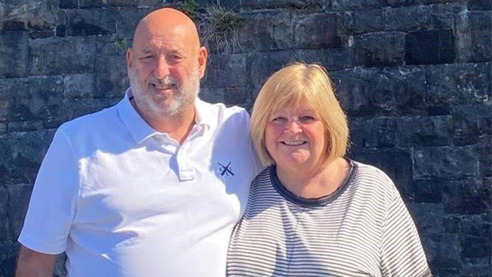 A man in a white t-shirt and a women with a blonde bob