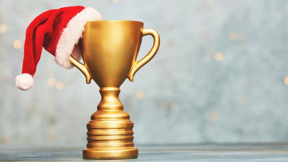 Trophy with a Christmas hat on