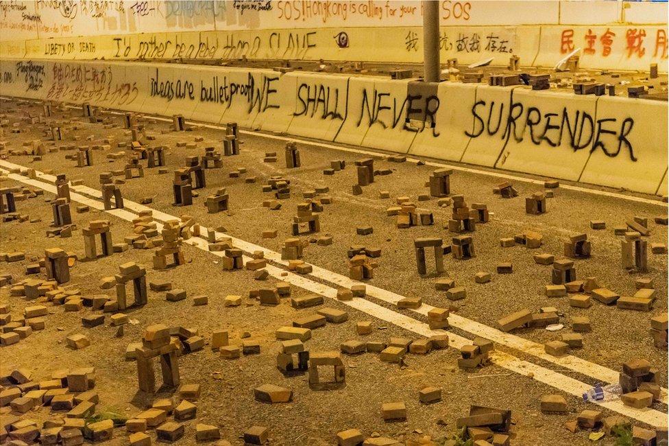 HONG KONG, CHINA - NOVEMBER 18: Protesters use bricks to barricade near Hong Kong Polytechnic University in the Tsim Sha Tsui district on 18 November 2019 in Hong Kong