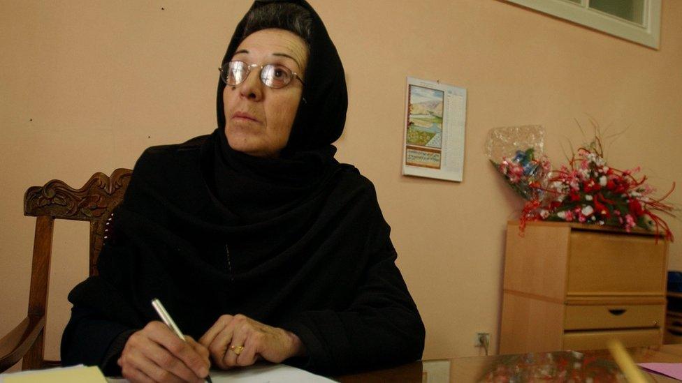 Suhaila Siddiqi works at her desk at the Public Health Ministry building in Kabul, Afghanistan.