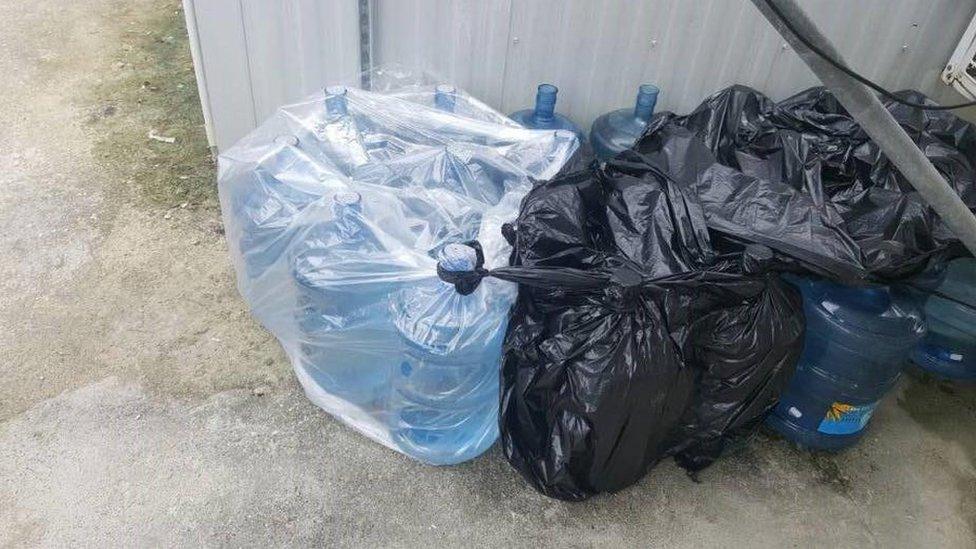 A collection of water bottles at Manus detention centre