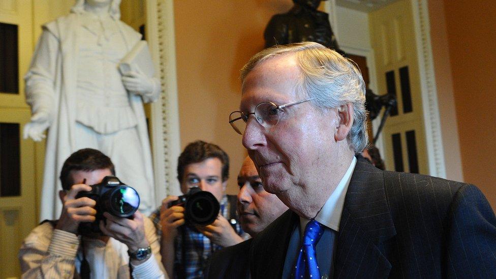 Mitch McConnell walks through the US Capitol.