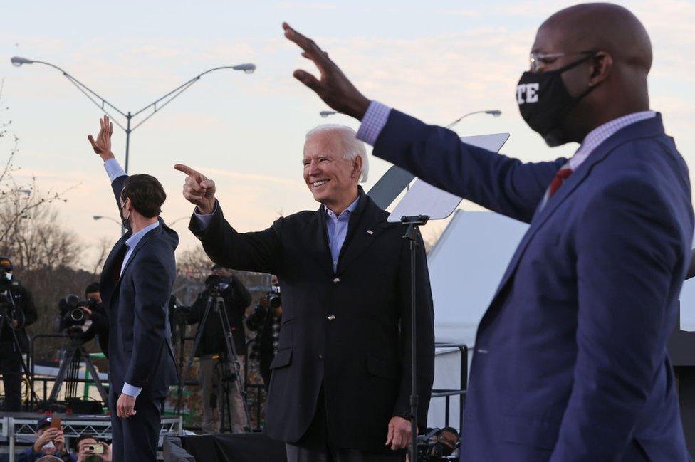 Joe Biden pictured with Jon Ossoff and Rev. Raphael Warnock on 4 January, 2021 in Atlanta, Georgia