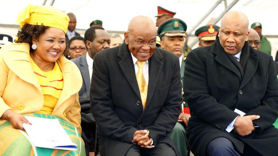 Newly appointed Lesotho prime Minister Thomas Thabane (C), leader of the All Basotho Convention (ABC) political party, his wife "Ma Isaiah Ramoholi Thabane (L) and Lesotho King Letsie III (R) react during Thabane"s inauguration on June 16, 2017 in Maseru