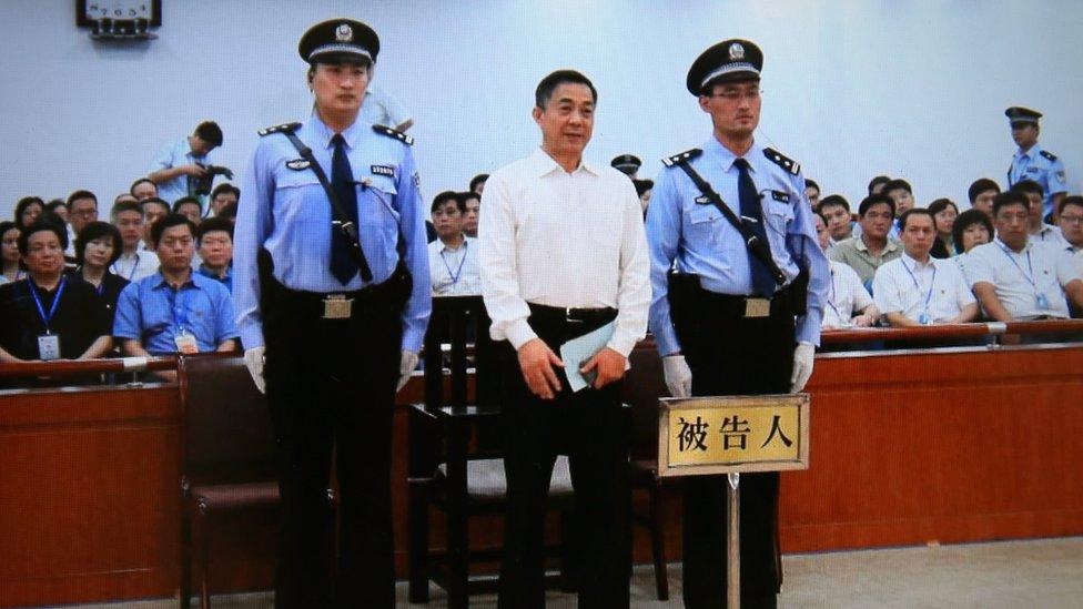 A screen shows the picture of the sentence of Chinese politician Bo Xilai on 22 September