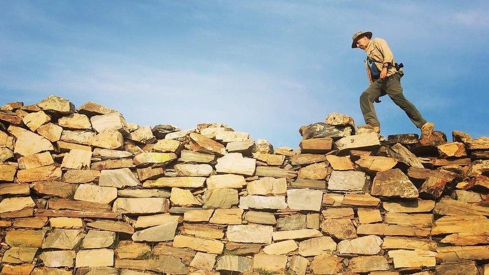 Treading on piled-up stones that became the first component of the now famous Great Wall, originally dating from the late 4th century BC, Inner Mongolia