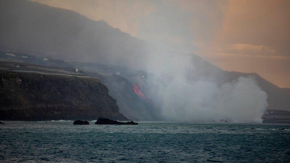 Lava flows from the Cumbre Vieja volcano towards the Atlantic Ocean.