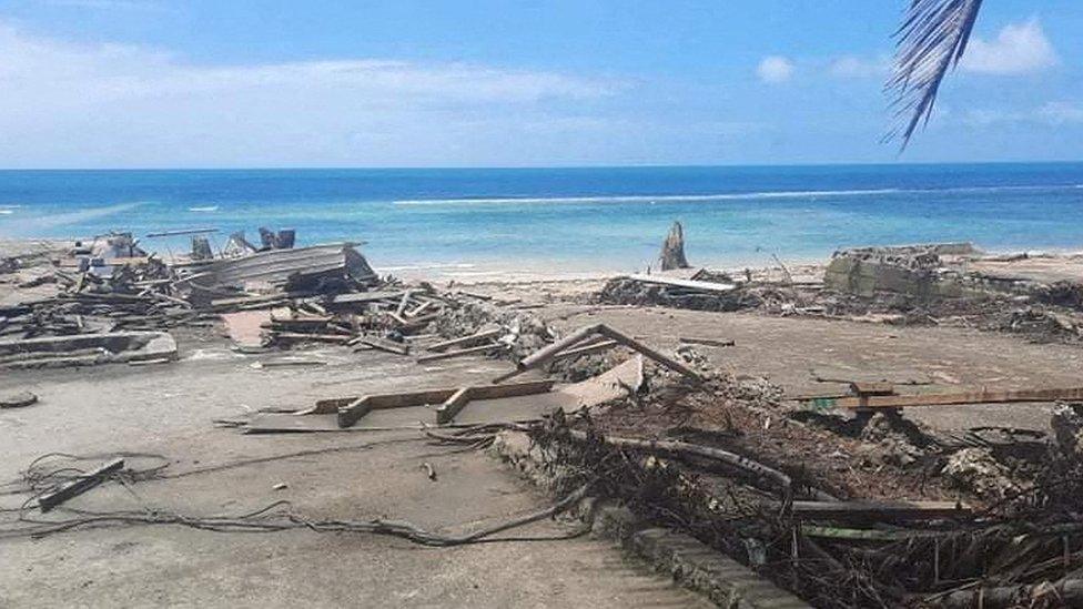 A view of debris and broken structures on a beach