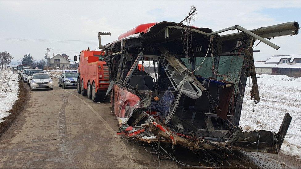 The wreckage of a vehicle at the scene of a crash between a bus and a train at a railway crossing in the village of Donje Medjurovo