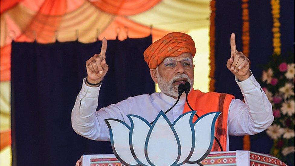 India's prime minister Narendra Modi (C) addresses a gathering during a Bhartiya Janata Party (BJP) rally ahead of Gujarat state elections at Dehgam, some 40 kms from Ahmedabad on November 24, 2022.