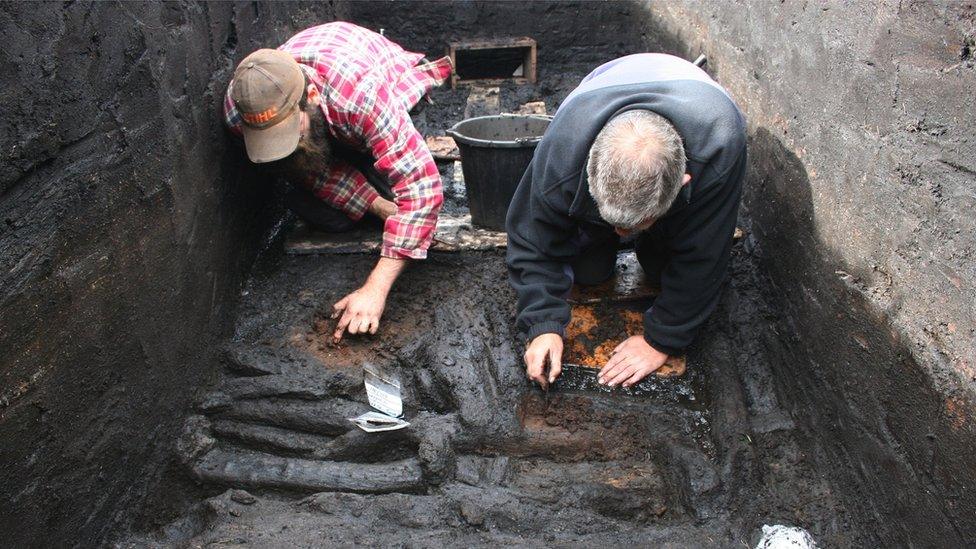 Men studying the ground