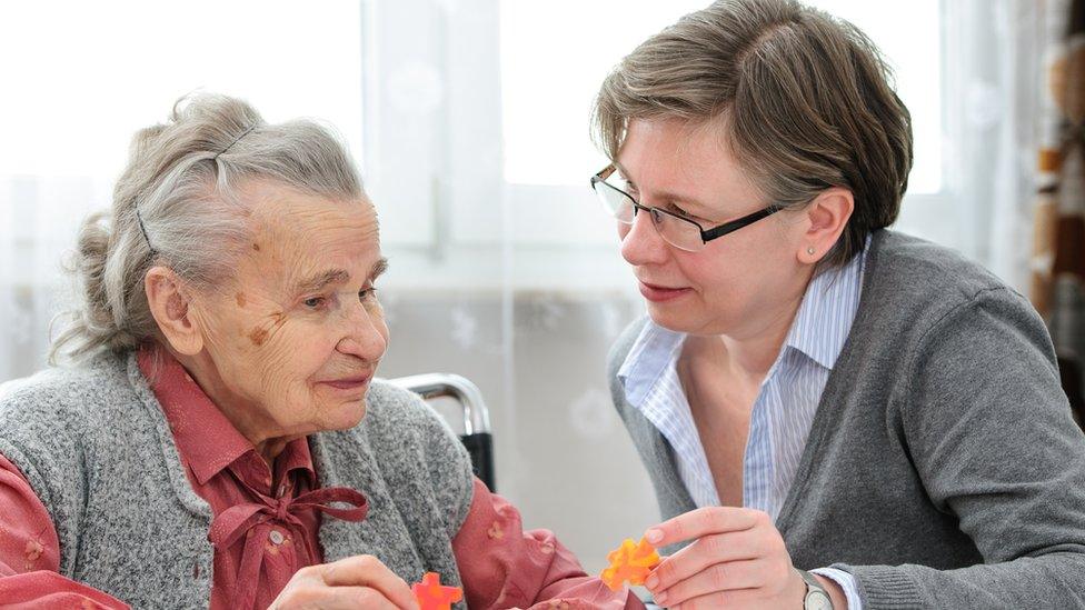 An elderly lady with her care nurse