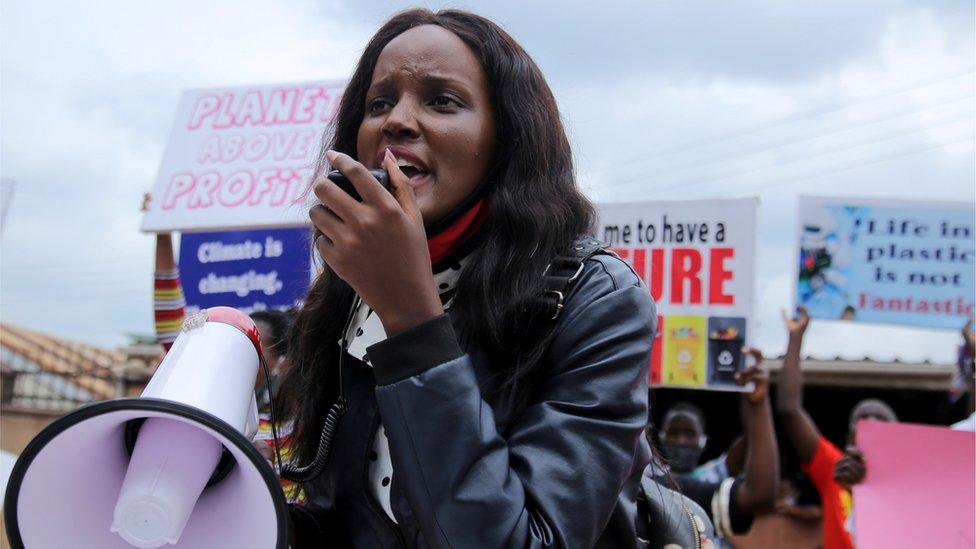 Ugandan climate change activist Vanessa Nakate, uses a megaphone with other activists holding placards advocating for climate change during a demonstration for the Global Climate Change in Luzira suburb of Kampala, Uganda September